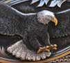 A bald eagle - with gold and platinum highlights - on an 1877 Sharps rifle.