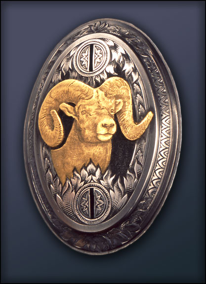 A grip cap with a gold inlay of a bighorn ram.