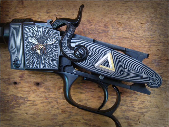 A uniquely engraved/inlayed hammer gun.
